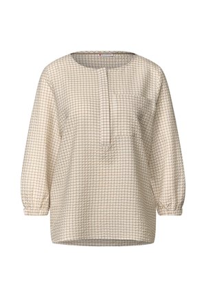 Top bianco con motivo a griglia color marrone chiaro, caratterizzato da un collo rotondo, maniche lunghe a sbuffo e una tasca frontale. Tessuto a rilievo.