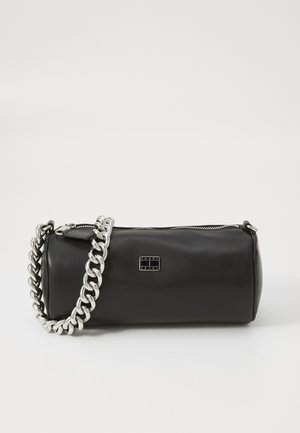 Black cylindrical handbag made of smooth leather. Features a silver chain strap and a metal logo plaque. Zip closure along the top.