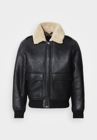 Black leather jacket with a cream faux shearling collar, front button closure, two large patch pockets, and ribbed cuffs and hem.
