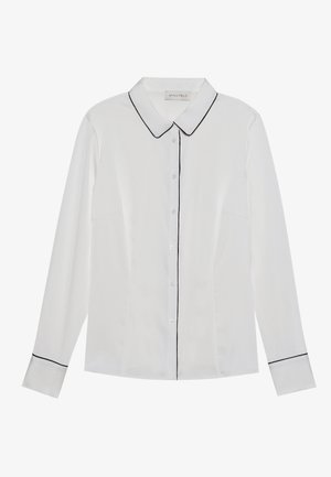 Valge pikade varrukatega särk terava kraega, musta ääristusega krae ja mansetid, millel on nööbid ees ja sirge lõige.