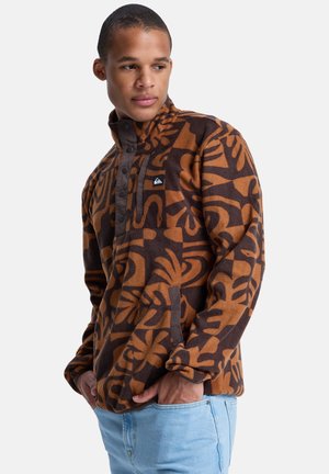 Bruine en beige fleece pullover met abstracte patronen, drukknopen als sluiting en zijzakken. Heeft een synthetische textuur en een relaxt model.