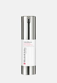 Vit cylindrisk flaska med silverfärgade accenter, utrustad med en pumpdispenser. Etiketten säger "Visible Difference Good Morning Retexturizing Primer."