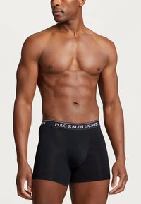Black boxer briefs with a snug fit, featuring a white "POLO RALPH LAUREN" logo on the waistband. Cotton material with smooth texture.