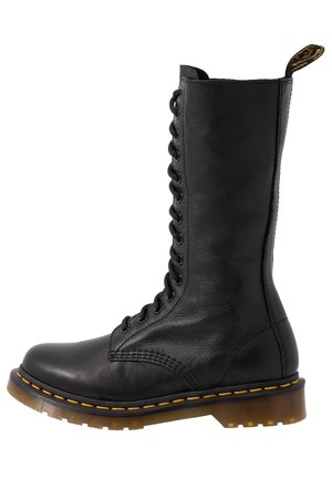 Black leather lace-up boot with a tall shaft, round toe, and textured surface. Features contrast yellow stitching and a sturdy sole.