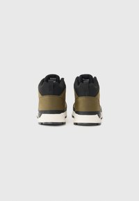Green and black high-top sneakers with contrasting panels, sturdy sole, and textured accents. Features pull tabs for easy wear.