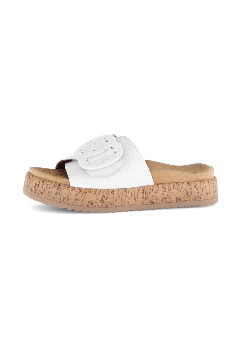 White slide sandal with a textured cork platform sole. Features a smooth leather upper and a prominent decorative buckle.