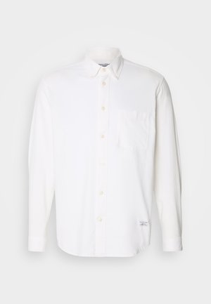 White long-sleeve shirt made of cotton with a button-down collar, single chest pocket, and subtle textured fabric.