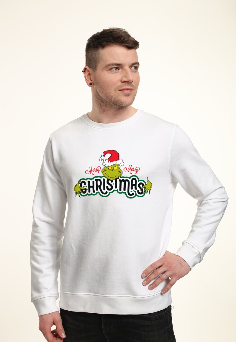 Felpa bianca con un grafico colorato del Grinch che indossa un cappello di Babbo Natale e il testo "Buon Natale" in verde e rosso.