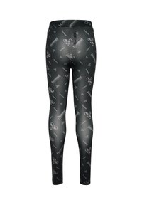Svarta leggings med en glänsande finish, prydda med upprepade vita logotyper och mönster. Designade för aktiv träning, åtsittande med elastisk midja.