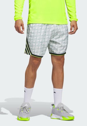 Light grey athletic shorts with 3D geometric pattern, neon yellow accents, black stripes, and fitted design. Worn with gray sneakers.
