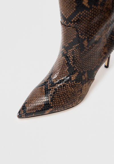 Brown and black pointed-toe ankle boot with a textured snake print pattern, featuring a high heel and sleek design. Smooth, glossy finish.
