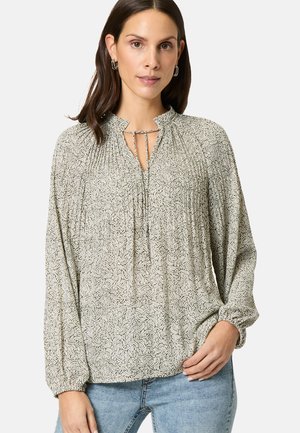 Lightweight, patterned blouse with a gathering detail, keyhole neck, and elasticized sleeves. Colors are predominantly cream and dark green.