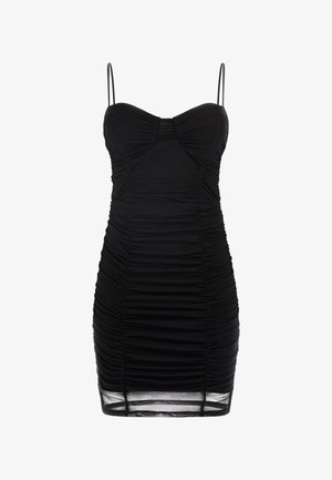 Black mini dress made of ruched fabric with thin spaghetti straps. It features a sweetheart neckline and sheer hem accents.