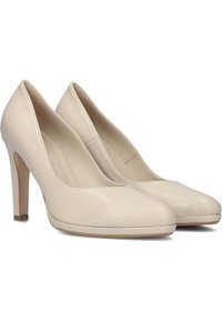 Beige leather high-heeled shoes with a smooth texture, rounded toe, and a stiletto heel. Clean design with minimal accents.