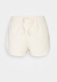 Ljusbeige bomullsshorts med elastisk midjeband och snörning, som har en mjuk, texturerad yta och en avslappnad passform.