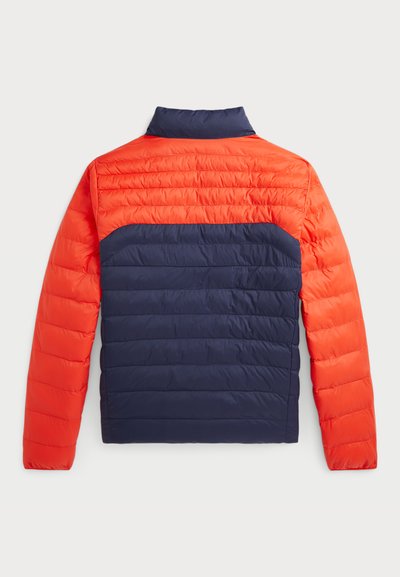 Padded jacket with a high collar, featuring an orange upper and navy lower section; quilted texture and structured shoulders.