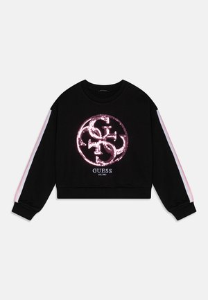 Sudadera corta negra con un gran logo de lentejuelas en la parte frontal. Tiene rayas rosa en contraste a lo largo de las mangas y puños acanalados.