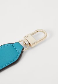 Turquoise leather keychain with a black border, featuring a gold metal clasp and round attachment ring. Smooth texture, no visible patterns.