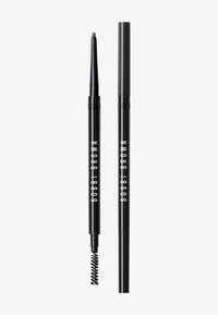 Crayon à sourcils noir avec une pointe biseautée et un goupillon à une extrémité. Présente un texte blanc "BOBBI BROWN" sur le côté. Design compact.