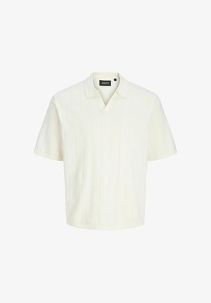 Krátký rukáv krémový pletený polokošile s jemným vertikálním žebrováním a malým límečkem, uvnitř límce označený "Aprel".