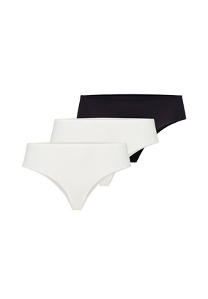 Trois slips féminins sans coutures en blanc et noir, disposés en pile décalée sur fond blanc.