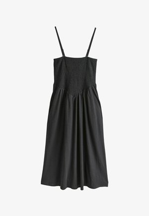 Fekete ruha vékony állítható pántokkal, gumírozott felsőrésszel és légies szoknyával. Sima anyagból készült, laza szabású, redőzött részletekkel.