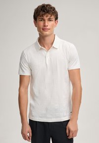 Witte polo met een gestructureerd patroon, korte mouwen, een klassieke kraag en drie knopen, gemaakt van lichtgewicht stof.