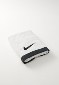 Fehér pamut törölköző fekete Nike logóval. Az egyik élén sötétszürke szegély található. Puha textúrájú, vastag és nedvszívó kialakítású.