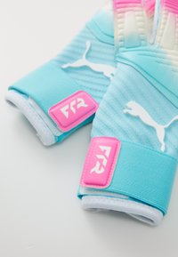 Pair of blue and pink Puma goalkeeper gloves with wrist straps and FR2 logo on a white background.