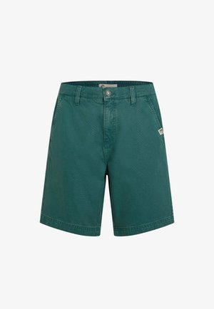Green cotton shorts with a smooth texture, featuring a single front pocket, metal button closure, and stitched hem.