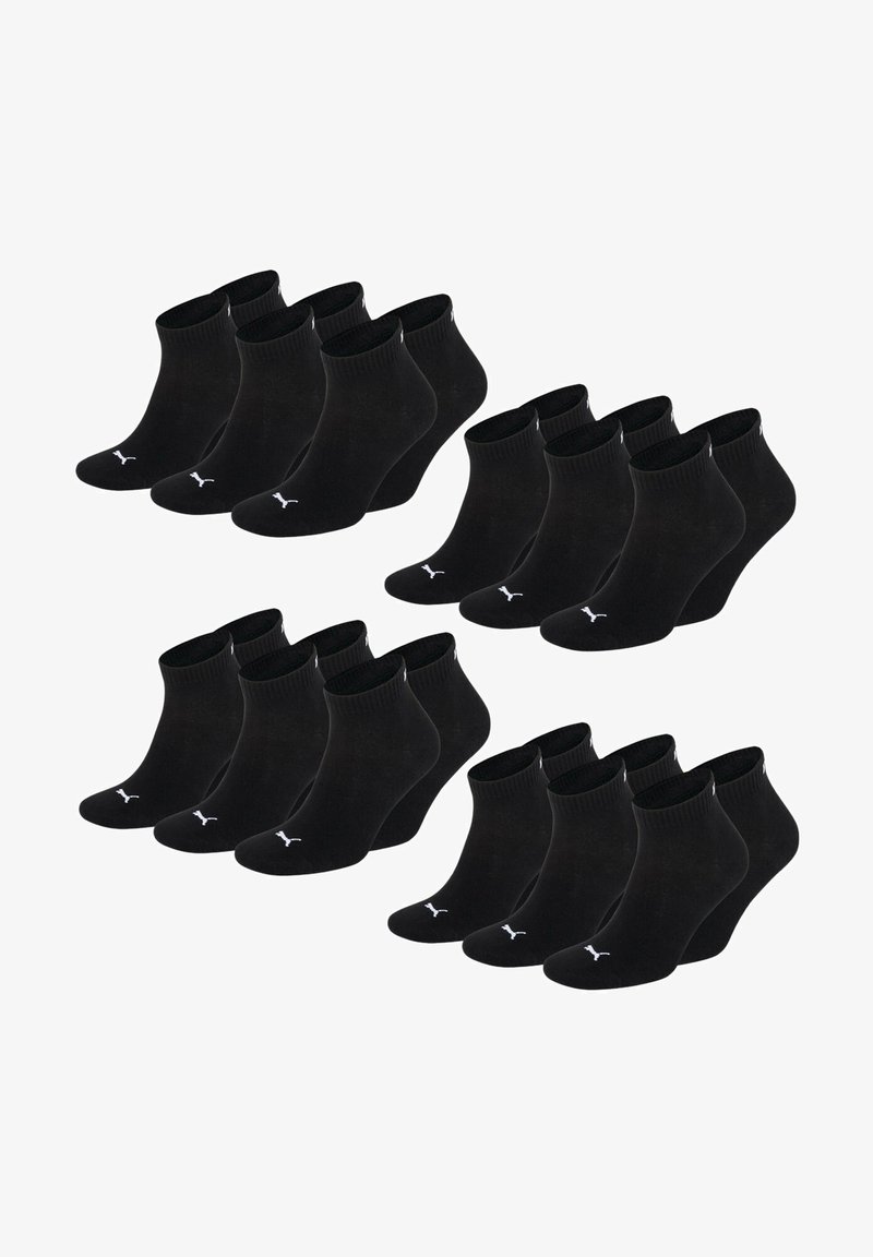 Black cotton ankle socks arranged in sets, featuring a ribbed cuff and subtle white logo on the ankle. Six pairs shown in two rows.