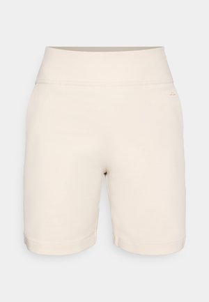 Bézs rövidnadrág széles elasztikus derékpánttal. Simas textúra, szegélyezett szegélyek, és egy kis logó részlet a derékpánton.