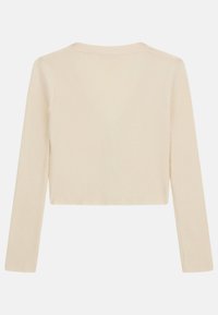 Maglietta a maniche lunghe color crema con scollo rotondo e design corto, caratterizzata da un tessuto testurizzato e spaccature laterali per un tocco in più.