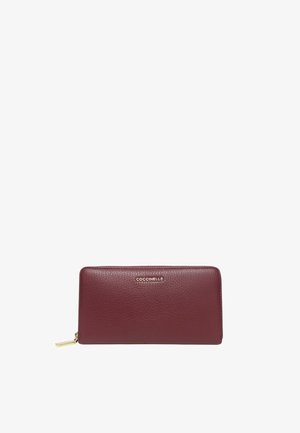Burgundy leather wallet with a textured surface, rectangular shape, gold-tone zipper pull, and brand logo embossed on the front.