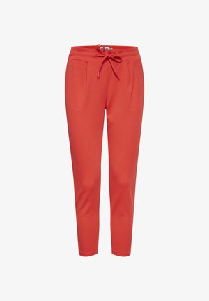 Red tapered sweatpants with an elastic waistband and drawstring, featuring side pockets and a smooth fabric texture.