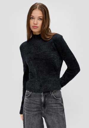 Black, fuzzy long-sleeve sweater with a high neckline, paired with gray denim jeans. Texture appears soft and warm.