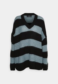 V-neck sweater featuring wide black and light blue stripes, soft textured knit, long sleeves, and relaxed fit.