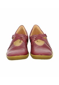 Burgundy leather shoes with an elegant cross strap design, rounded toe, and a flexible rubber sole. Interior features a beige lining.