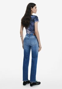 Sinised teksad sirge lõikega ja kahe tagataskuga, koos läbipaistva sinepikollase gradientsinise särgiga. Mustad tossud roheliste detailidega.