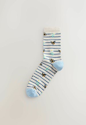 Striped ankle sock in cream and light blue with black bees and floral patterns. Soft texture; ribbed cuff; reinforced heel and toe.