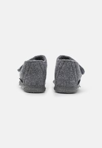 Gray felt slippers with a soft texture, rounded back, and minimal stitching. Features a strap detail for secure fit. Flat rubber sole.