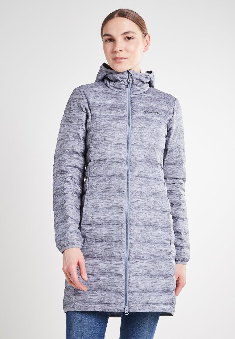 Abrigo largo acolchado gris con capucha y cremallera frontal. Presenta una tela texturizada con un patrón mezclado, acompañado de bolsillos laterales.