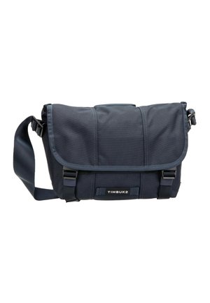 Navy blue Timbuk2 messenger bag with adjustable shoulder strap, front flap, two buckle closures, and visible brand label.
