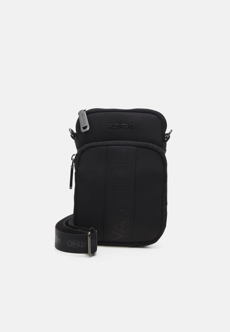 Black nylon crossbody bag with a zip closure, textured logo on the front, and an adjustable strap featuring branding. Smooth finish throughout.