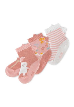 Three pairs of toddler socks in pink and white; one with a white rabbit, one with floral patterns, and one with pink and white stripes.