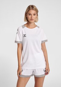 White athletic t-shirt with grey accents, round neckline, and short sleeves. Features a textured fabric and a logo on the chest.