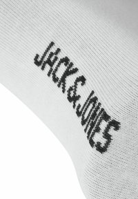 Chaussette en tissu blanc avec logo texte noir "JACK & JONES" tricoté près de la cheville.