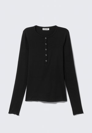 Black long-sleeve shirt in soft fabric with a rounded neckline, featuring a buttoned placket and a fitted silhouette.