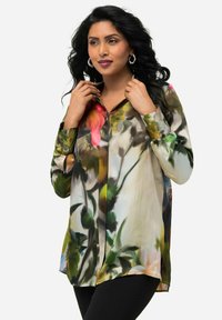 Bluse mit Blumenmuster aus leichtem, halbtransparentem Stoff. Mit langen Ärmeln, Knopfleiste vorne und einem lockeren Schnitt mit abgerundetem Saum.