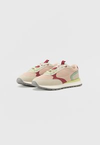 Sport shoes with a mesh and suede upper, featuring a mix of light beige, red, and green accents, and a gray rubber sole.